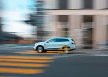 white and yellow sedan on road during daytime