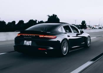 running black Porsche sedan