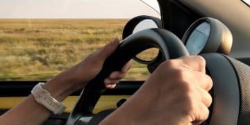 person with white watch driving car