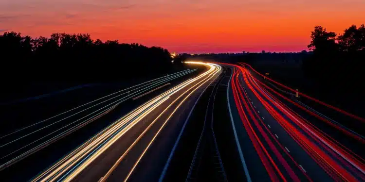 time-lapse photography of road under gray and orange sky