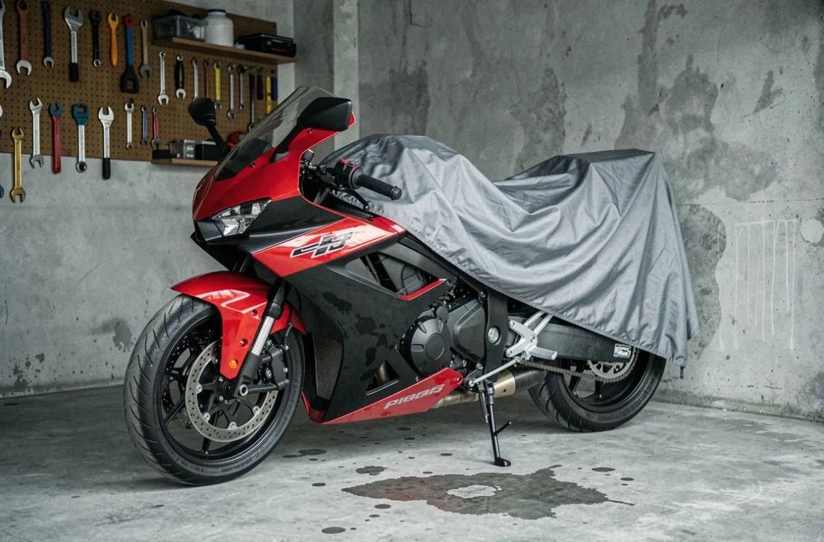 Moto de sport garée dans un garage et partiellement recouverte d'une housse de protection avant suspension d'assurance