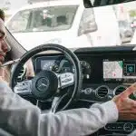 man in gray sweater driving car