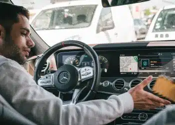 man in gray sweater driving car