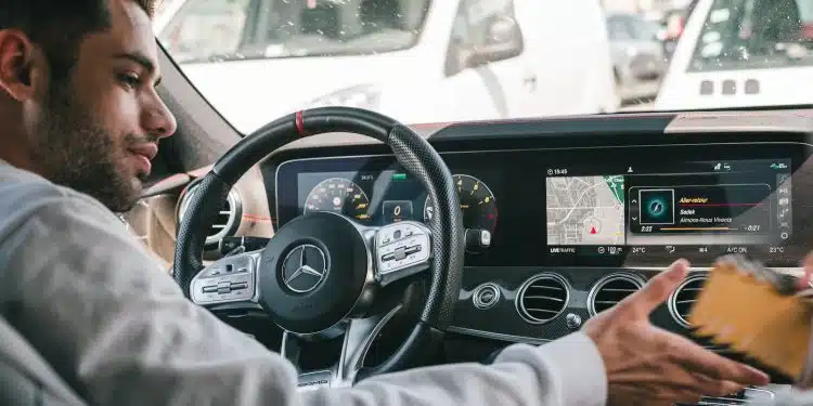 man in gray sweater driving car